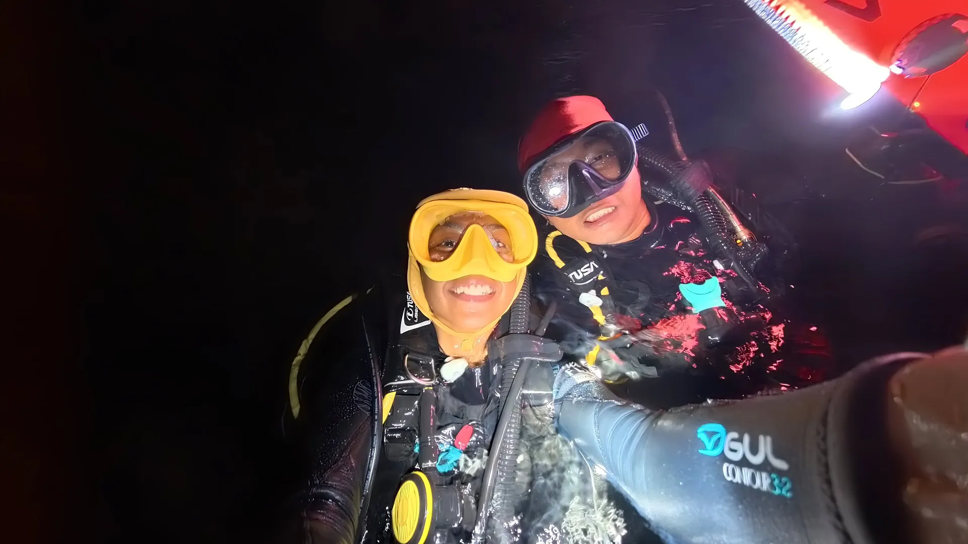 Two divers taking a selfie on a night dive