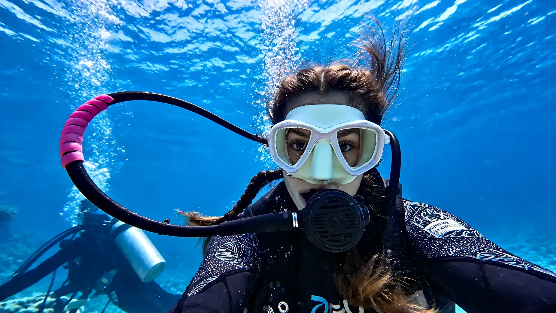 Smiling diver taking an underwater selfie