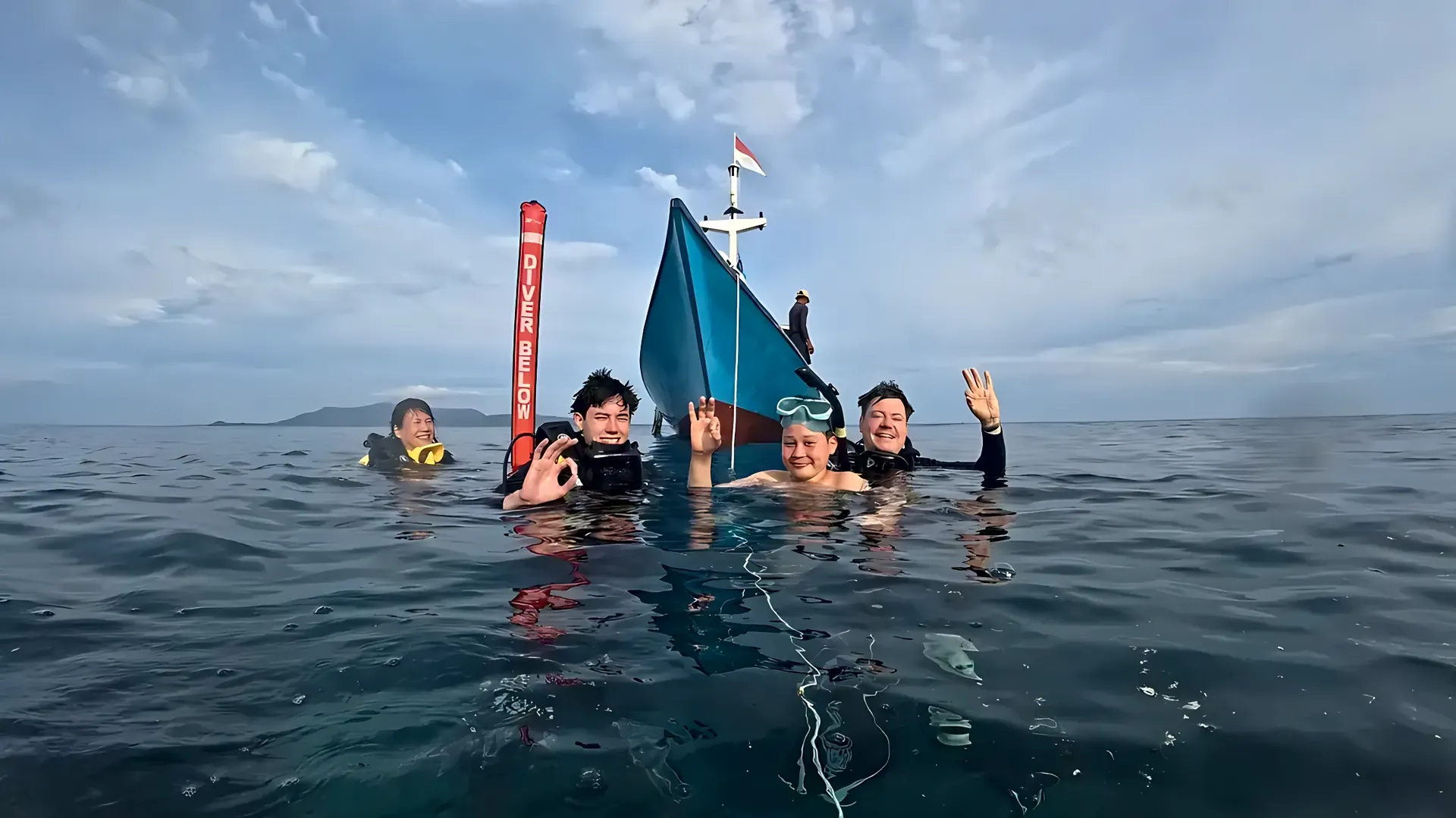 Divers at the surface next to the dive boat